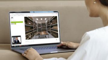 A person on laptop, enjoying virtual tour of Bentley's factory in Crewe. 