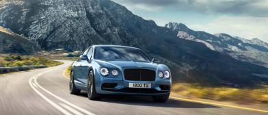Flying Spur W12 S front three quarters driving away from a rocky hill