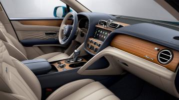 View over looking driver's seat of Bentley Bentayga EWB Azure, featuring Grand Black veneer with Mulliner Overlays and Aluminium Console.