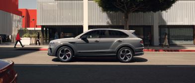 Bentley Bentayga S in Cambrian Grey colour, driving along urban setting featuring 22 inch S Directional Wheel - Black Painted and Polished.