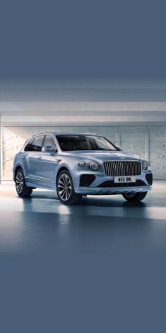 Bentley Bentayga A - V8 in Silverlake colour, side angled view featuring 21 inch Five Twin-Spoke Wheels and fluted chrome grille.