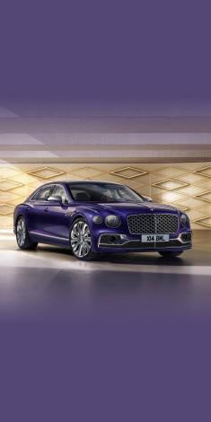 Front side angled view of Bentley Flying Spur Mulliner W 12 in Tanzanite purple colour, featuring 22 inch Mulliner Wheel Painted and Polished Bright and matrix grille behind vertical