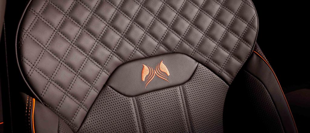 Bentley Bentayga [Model]'s front seat in focus, featuring detailed criss cross stitching and Orange flame piping.