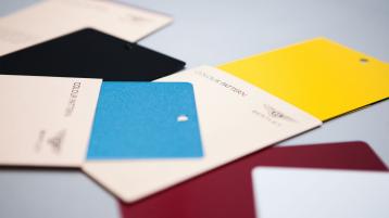 Photograph of colour cards scatterd on table with Bentley Mulliner bespoke colours