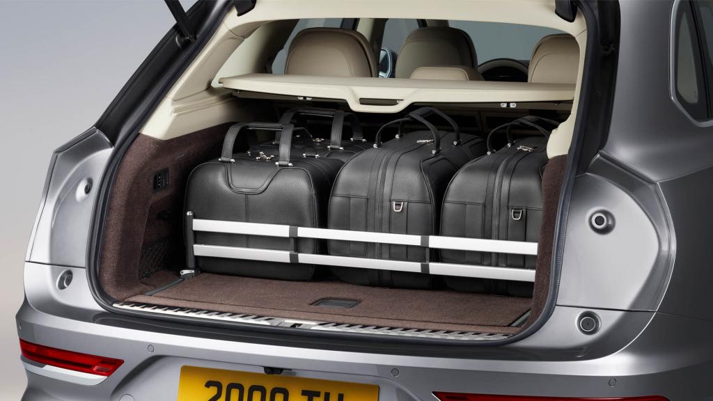 Bentley Bentayga EWB in Moonbeam colour with boot open, with bags placed in lightweight sliding Load Assist Tray  