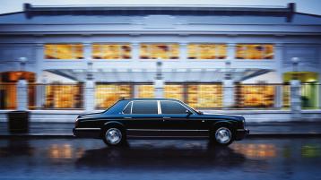 Side view of Bentley Arnage, driving through an urban setting.