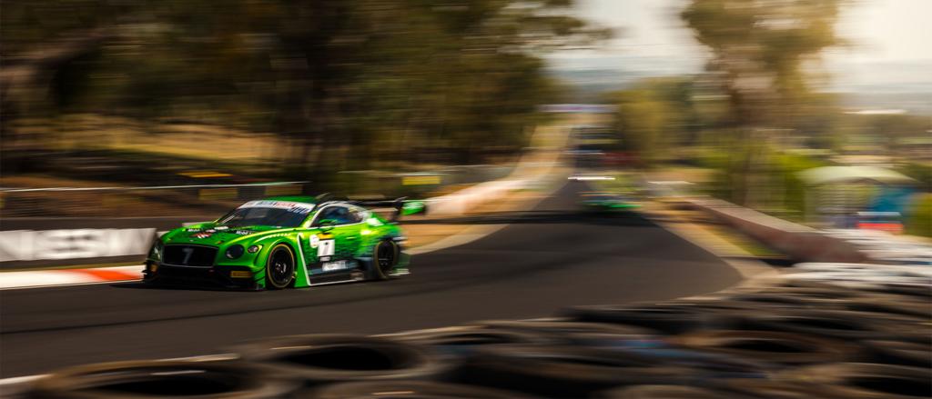 Side angled view of Bentley Continental GT 3 in Lime Green featuring Carbon fibre front splitter and aerodynamic fenders with hooded bonnet.