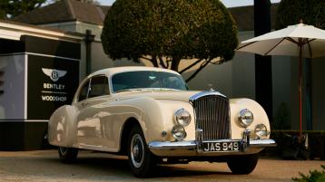 Bentley R-Type Continental 1952, front side angled view featuring Flying B radiator mascot, vertical vaned radiator - parked outside Bentley Woodshop.