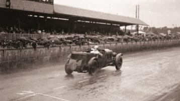 Bentley Speed Six, rear view, driving on a race track in rain
