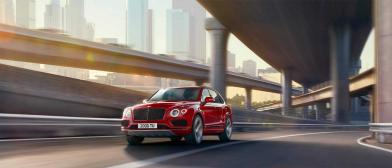Bentayga V8 driving on city road under overpass