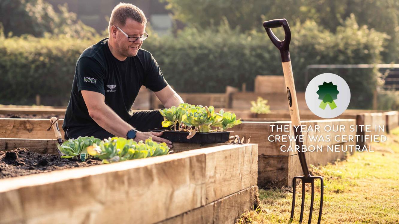 Glossed view of person gardening at Bentley's Heaquarters in Crewe, with a rake in view.  