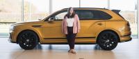 Sina stood in front of a Bentayga.