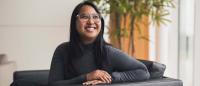 Yelena sat on a chair, smiling.