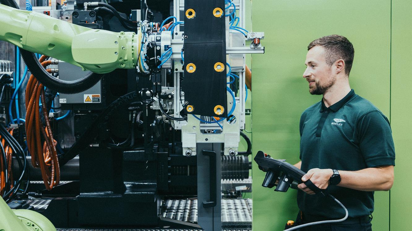 Bentley maintenance technician looking at/working on machinery.