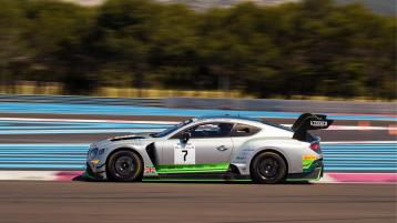 Side view of Bentley Continental GT3 featuring Carbon fibre front splitter, rear wing and body panels, driving on a race track 