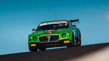Bentley Continental GT3 in Apple Green, with accentuated sports spoiler driving on racetrack with sky in backdrop
