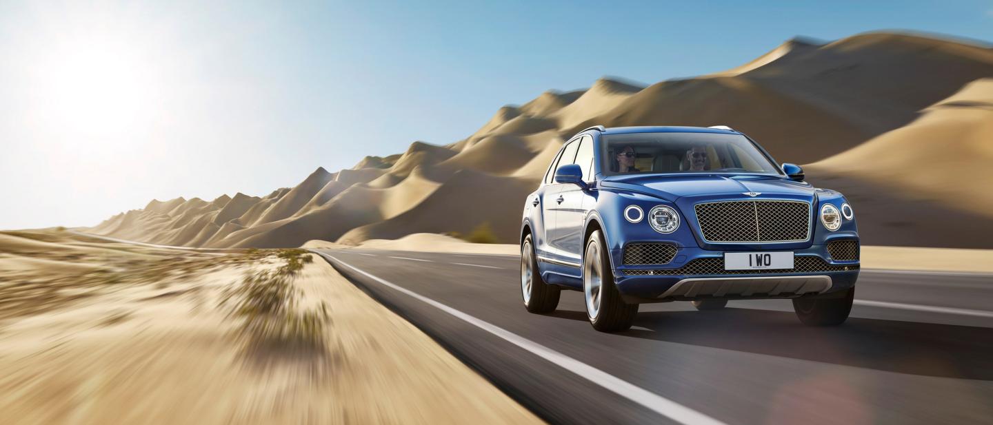 A 2021 Bentley Bentayga driving in rural environments