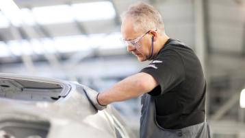 A craftsman working on fabrication of Bentley, in production line at Bentley Factory, Crewe.