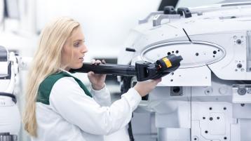 A technician working on Bentley chassis under manufacturing process.