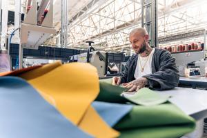 A seamster working on leather hide in Bentley Factory, Crewe.