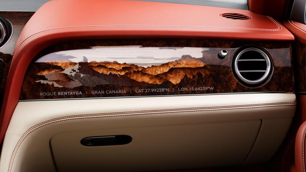Interior passenger side view of Bentley's bespoke marquetry featuring mountain imagery in Open pore Dark Burr Walnut.