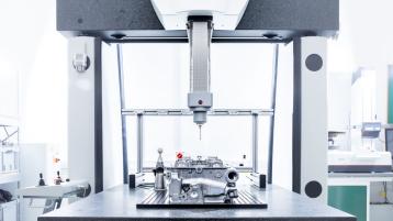 A 3D Coordinate measuring machine, with probe set to measure dimensions of engine block. 