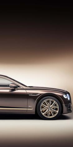 Front side quarter view of Bentley Flying Spur Hybrid Odyssean Edition,in [Arabica/ Spectre/ Havana] colour featuring 21” ten twin-spoke wheels