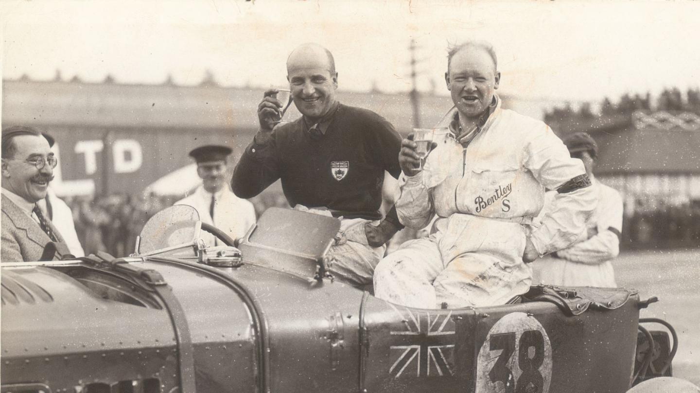 Dudley Benjafield and Eddie Hall sat on their race winning Bentley celebrating victory at Le Mans