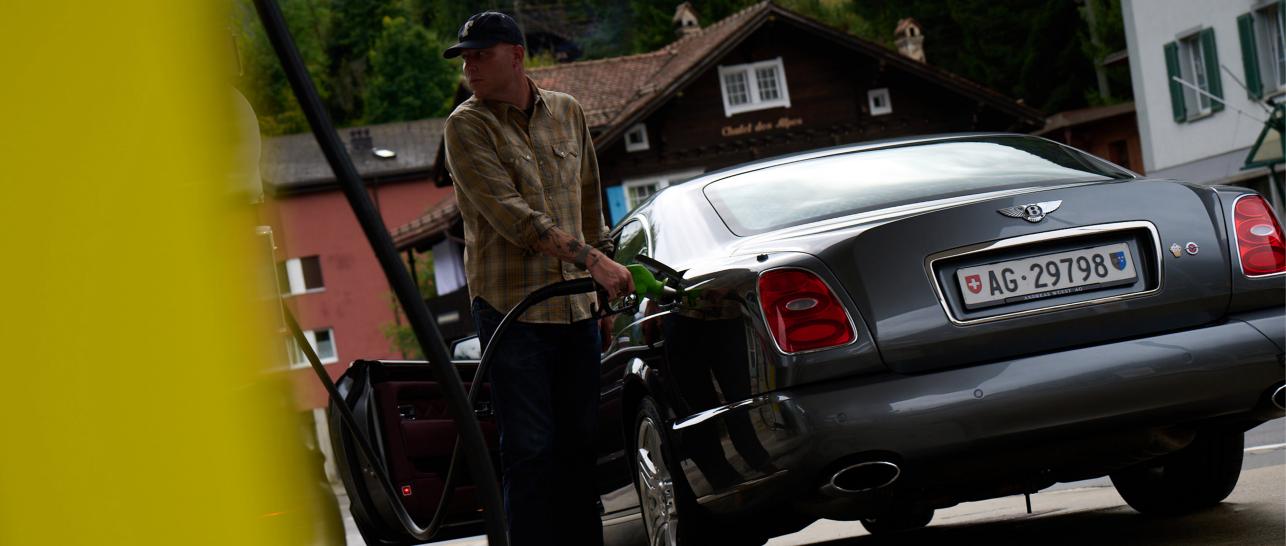 Andy Wuest filling up his Bentley Brooklands at a petrol station in Switzerland