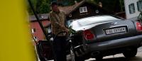Andy Wuest filling up his Bentley Brooklands at a petrol station in Switzerland