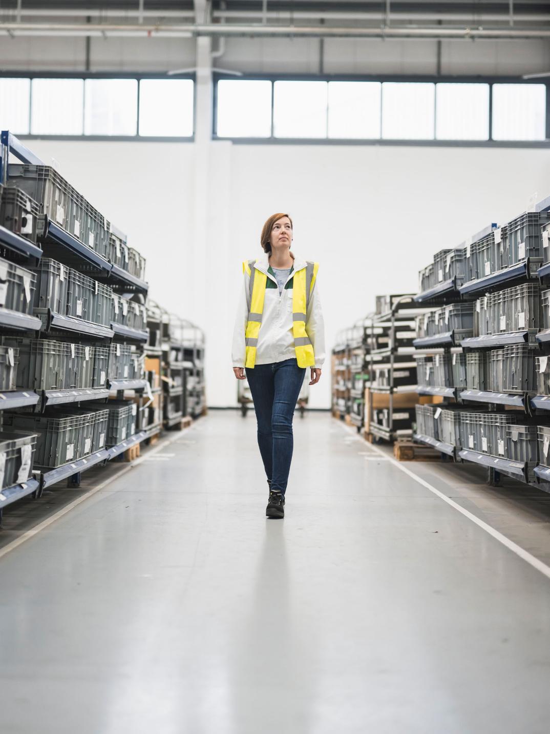 Fanny Weiss walking through the logistics warehouse.
