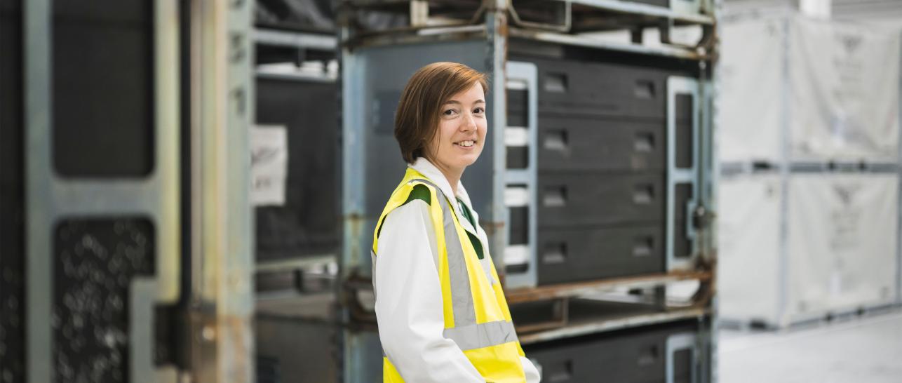 Fanny Weiss stood facing the camera, in the logistics warehouse.