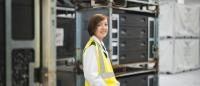 Fanny Weiss stood facing the camera, in the logistics warehouse.