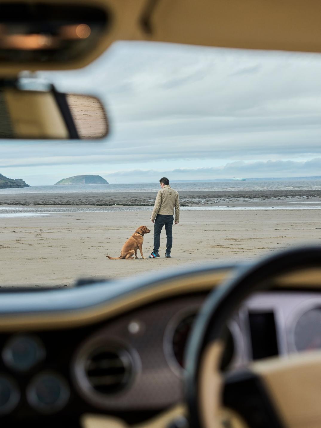 Hubert de Pelet and his dog seen through the front window of his Bentley Arnage T.