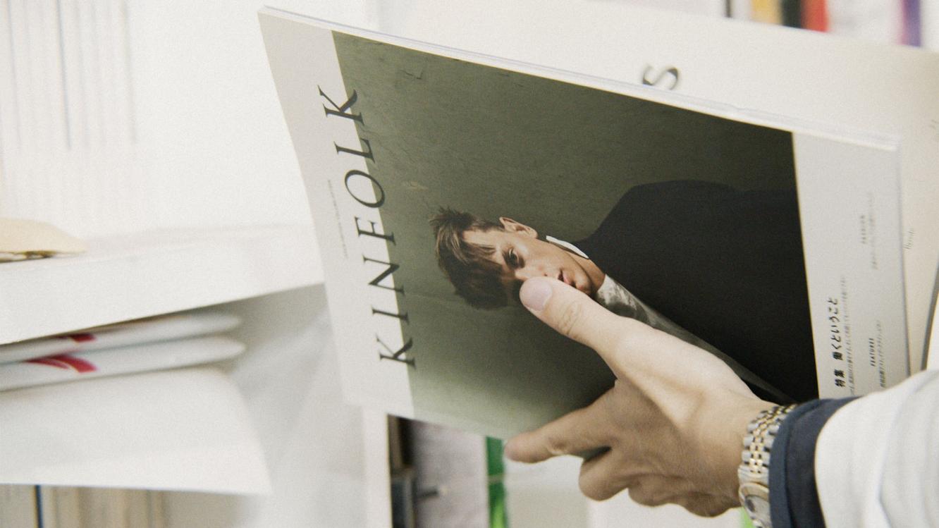 Kato looking through a copy of Kinfolk.