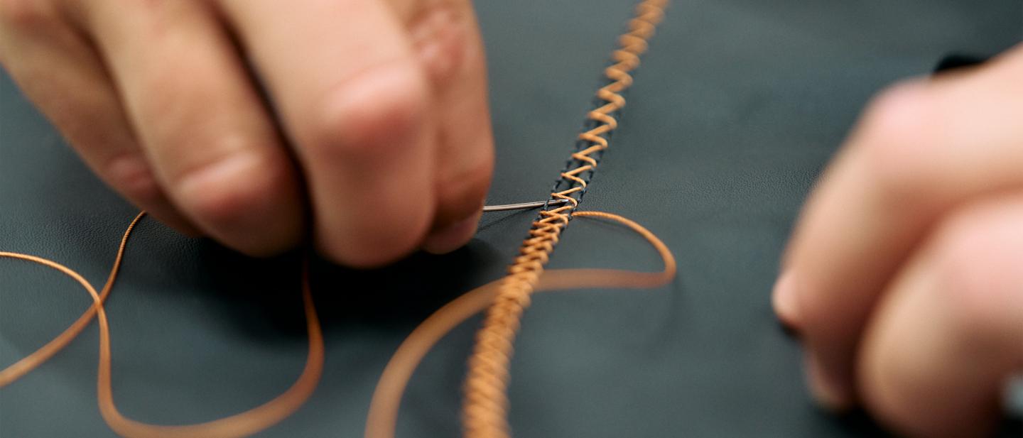Close up of a Bentley colleague stitching.