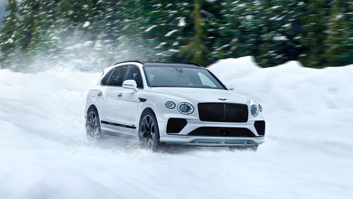 Bentley Bentayga driving through snow.