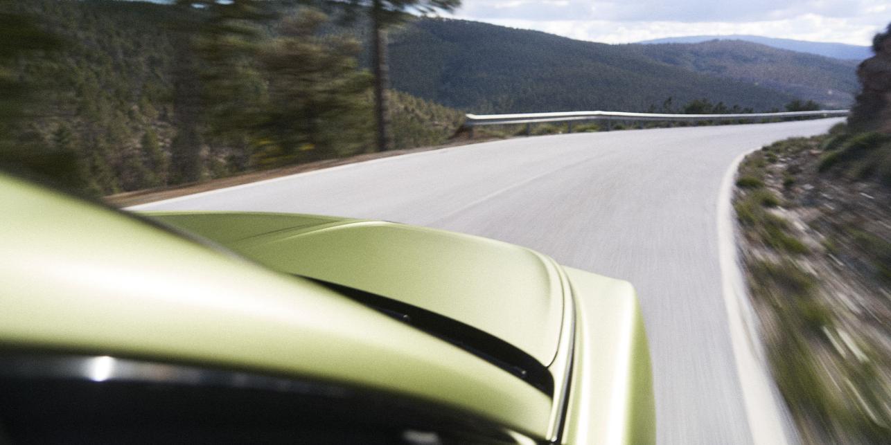 Bentley Torcal being driven with hills in the background.