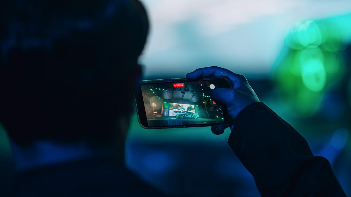 Person recording Bentley Supersports on stage.