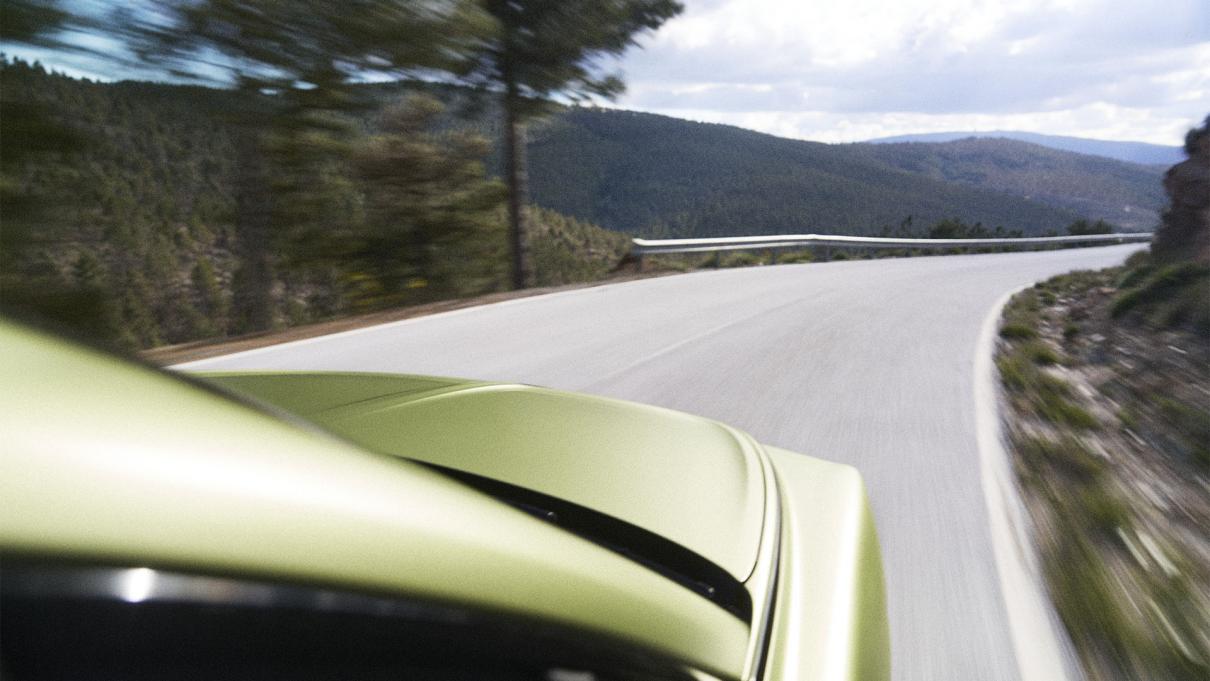 Bentley Torcal being driven with hills in the background.