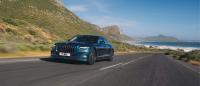 Front 3/4 view of the Bentley Flying Spur driving with hills behind.