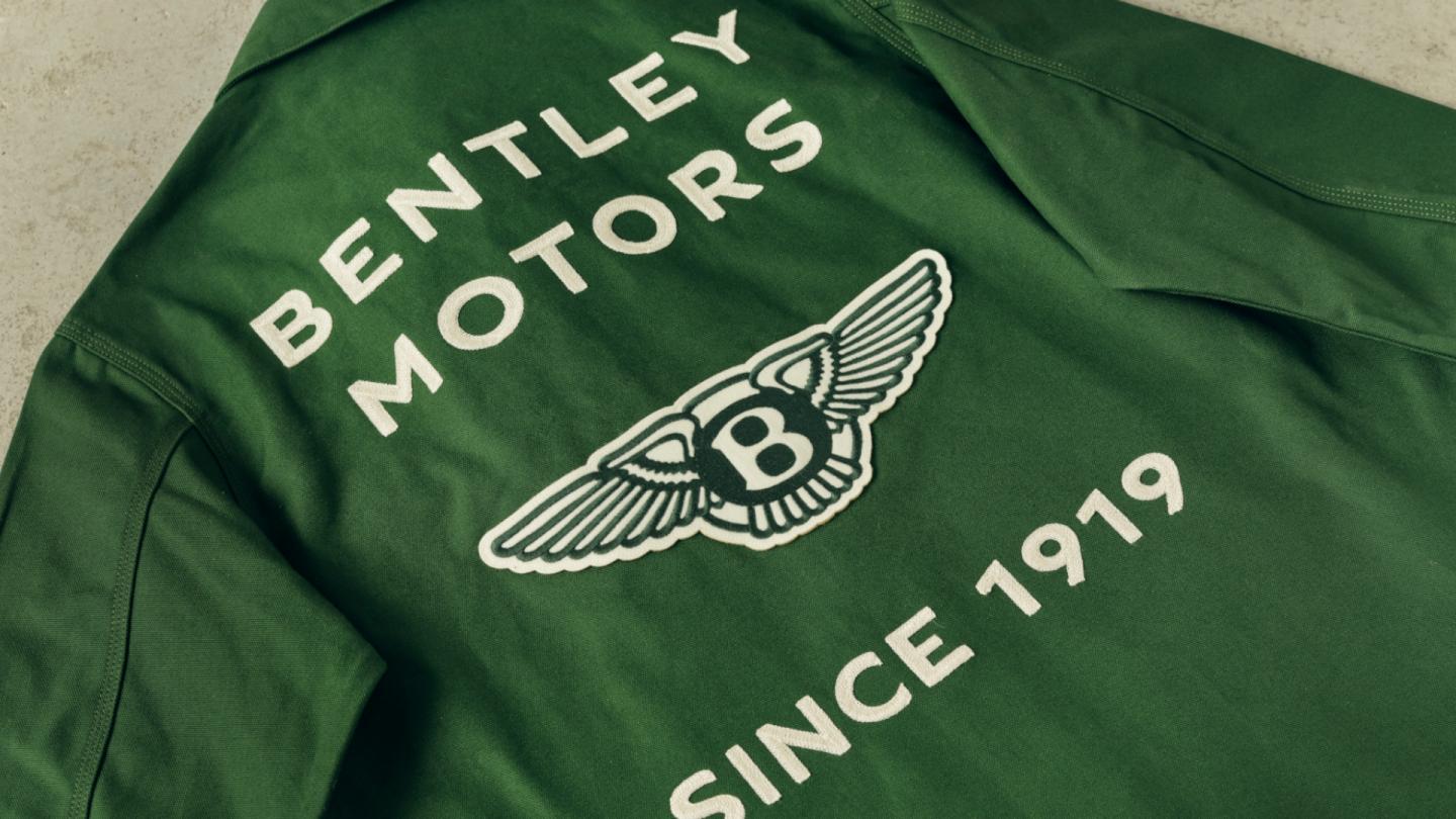 Close up of the embroidery on the back of the chore jacket in Bentley green