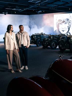 Bentley museum featuring Bentley Blowers in background with two people in view.  