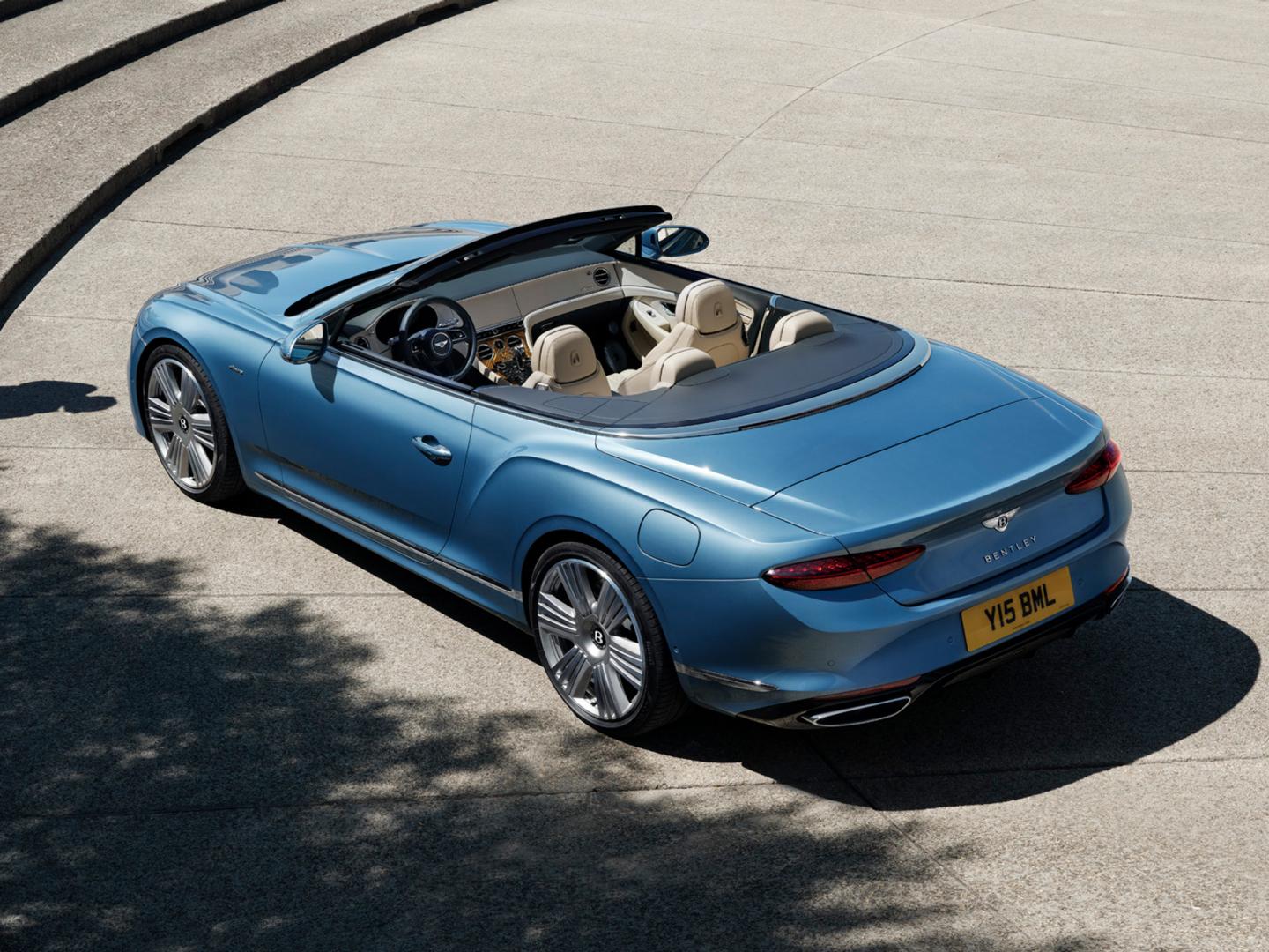 Rear three quarter of the new Continental GTC Azure in Light Windsor Blue parked in an urban environment