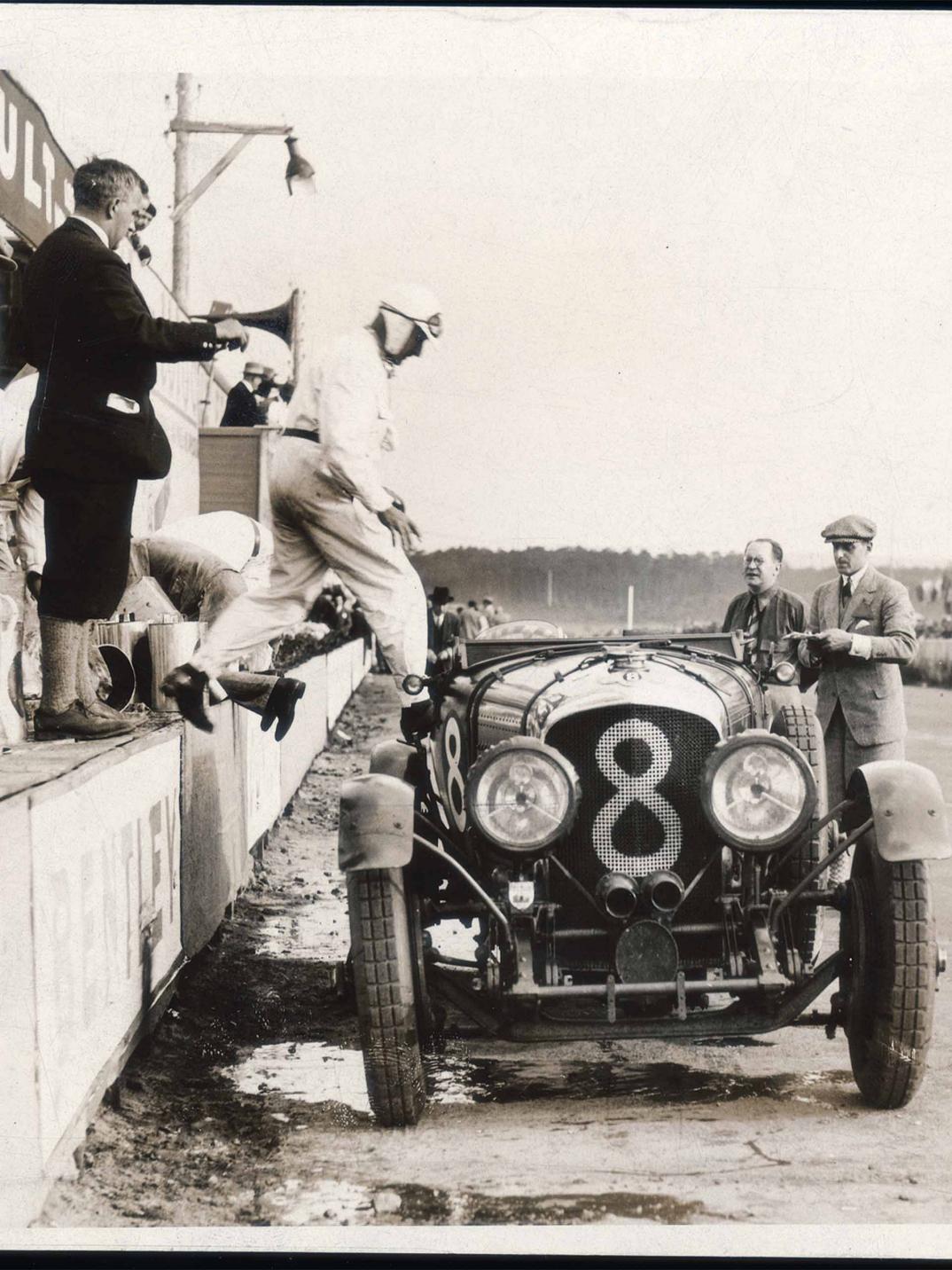 Racer driver about to enter  Bentley Blower - Car number 8, front view.