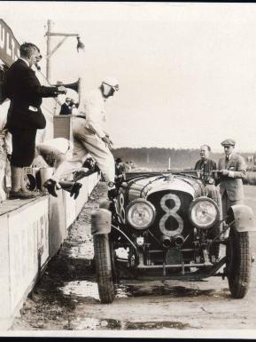 Racer driver about to enter  Bentley Blower - Car number 8, front view.