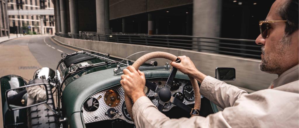 Driver view of Bentley Blower Jnr featuring Diamond Milled Aluminium veneer, being driven in an urban setting