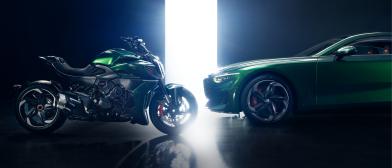 Side view of Batur by Mulliner and Diavel for Bentley in Scarab Green face to face with narrow bright  floor to ceiling stage lighting inbetween 