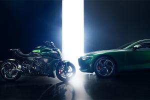 Side view of Batur by Mulliner and Diavel for Bentley in Scarab Green face to face with narrow bright  floor to ceiling stage lighting inbetween 