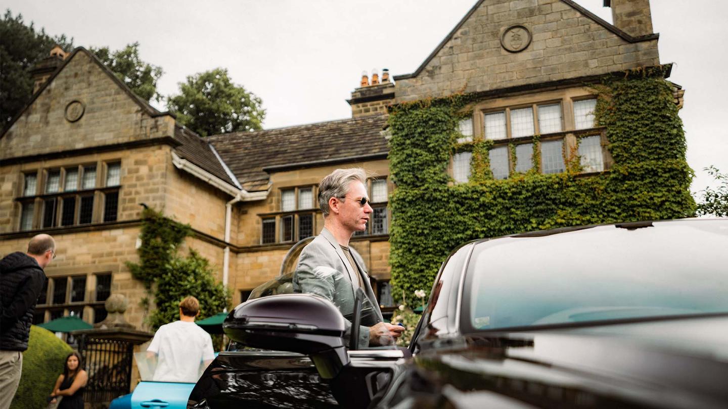 A person standing infront of Bentley Flying Spur